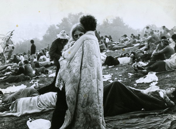 hippies hugging in blanket