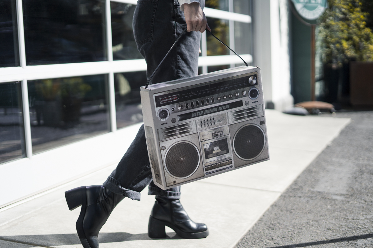 A person walking with a boombox gift box
