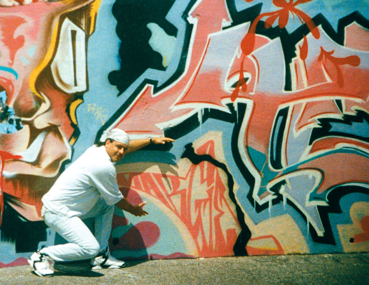 Man next to graffiti wall