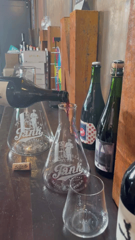 A .gif of a bottle of wine being poured into a 750 Ml decanter.