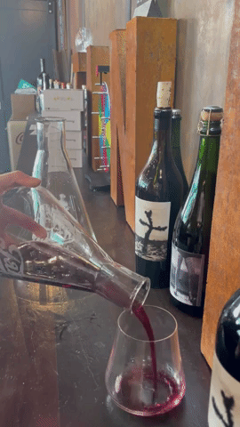 A .gif of wine being poured into a wine glass.